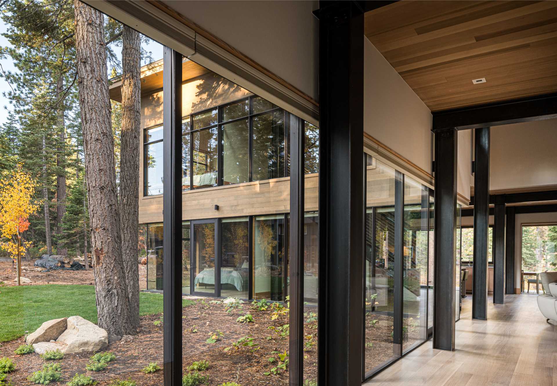 A hallway in this modern home is flooded with natural light from the windows that line it.