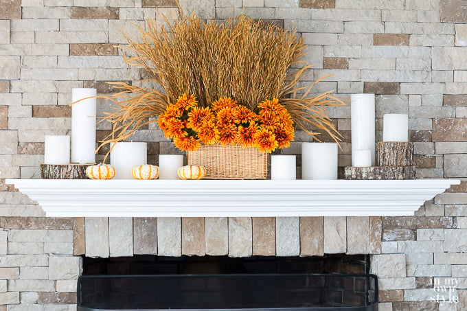 Fake flowers for fall in a basket on a mantel