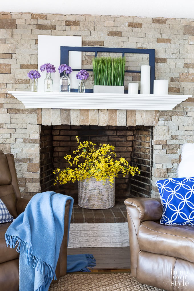 Fake flower decorating tips showing fake forsythia in fireplace box