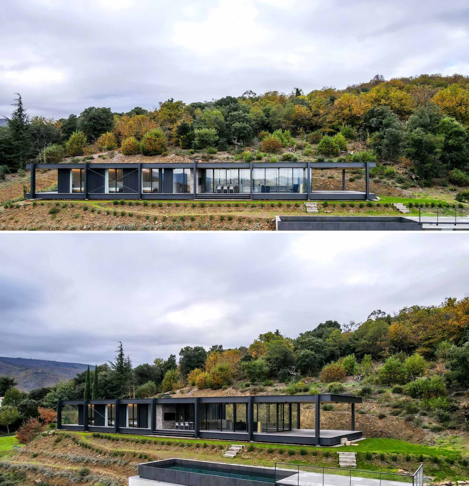 A modern house with a horizontal layout, walls of glass, and an exposed steel structure.