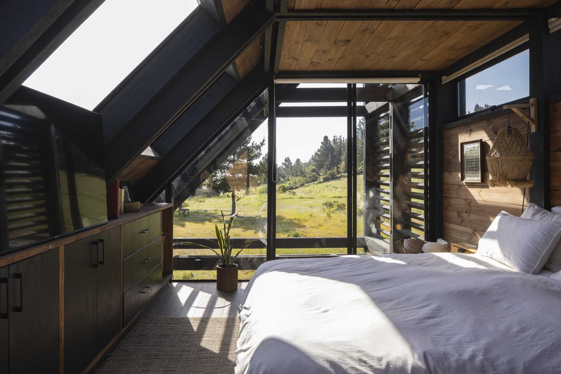 The bedroom of a small wedge-shaped home.