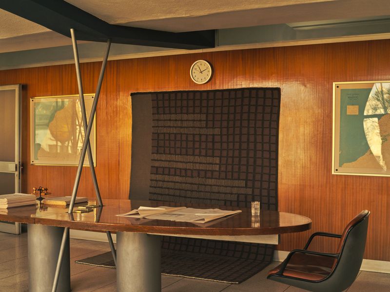 Image may contain Indoors Interior Design Furniture Table Chair Desk Wood Panels Wood Art Painting and Cup