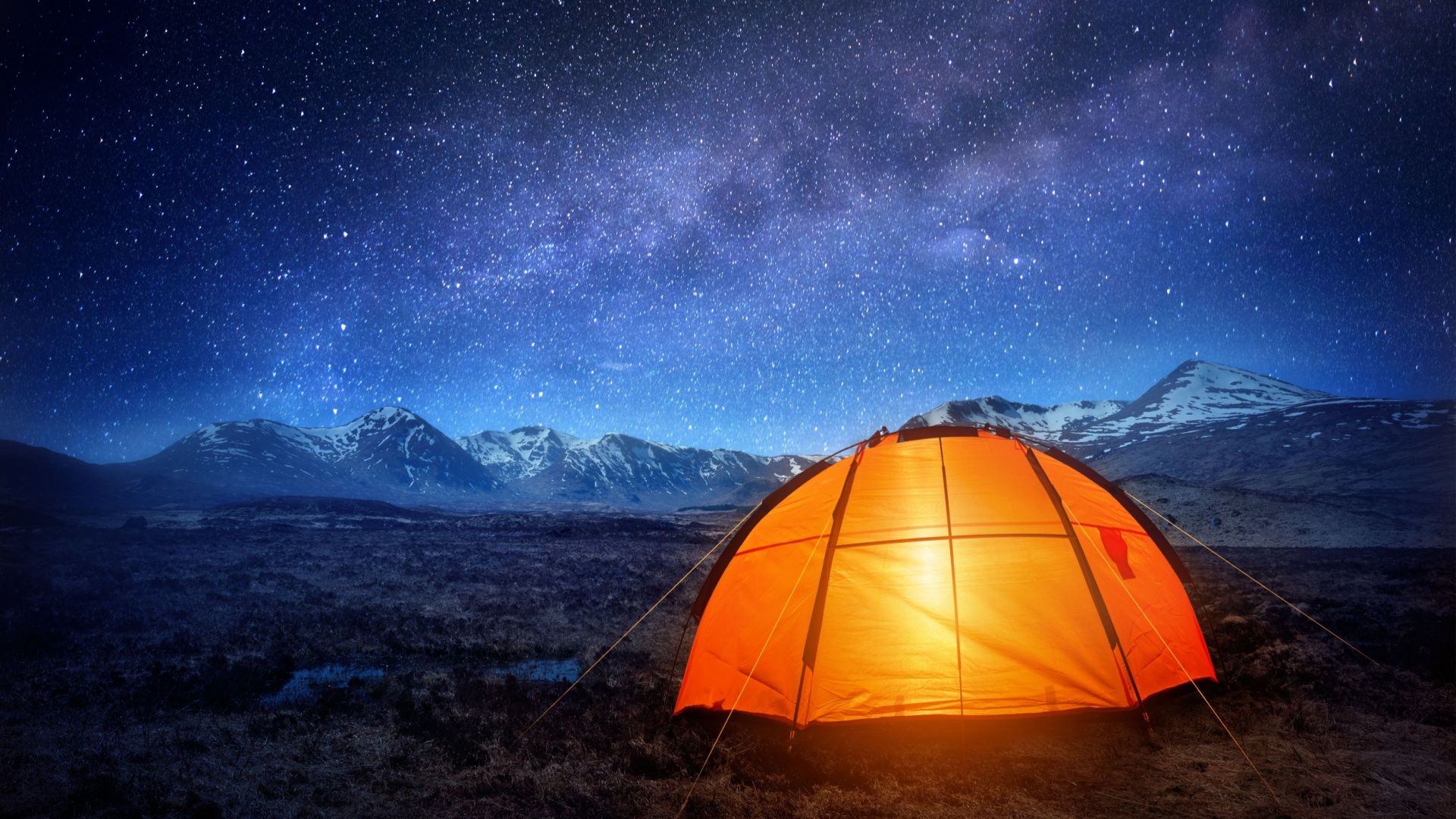 A glowing tent under the Milky Way. 