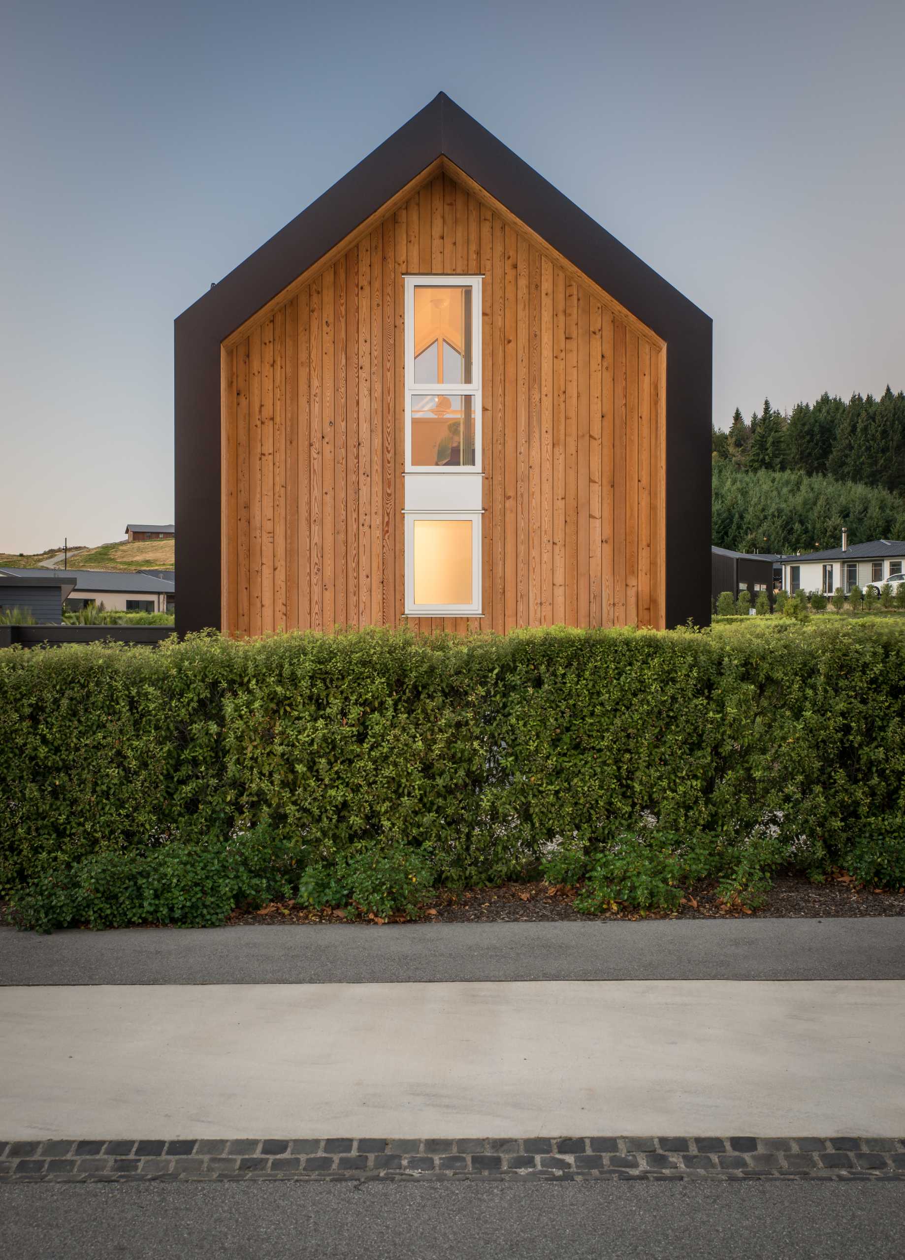 A small one bedroom home with an exterior of asphalt shingles and larch weatherboards.