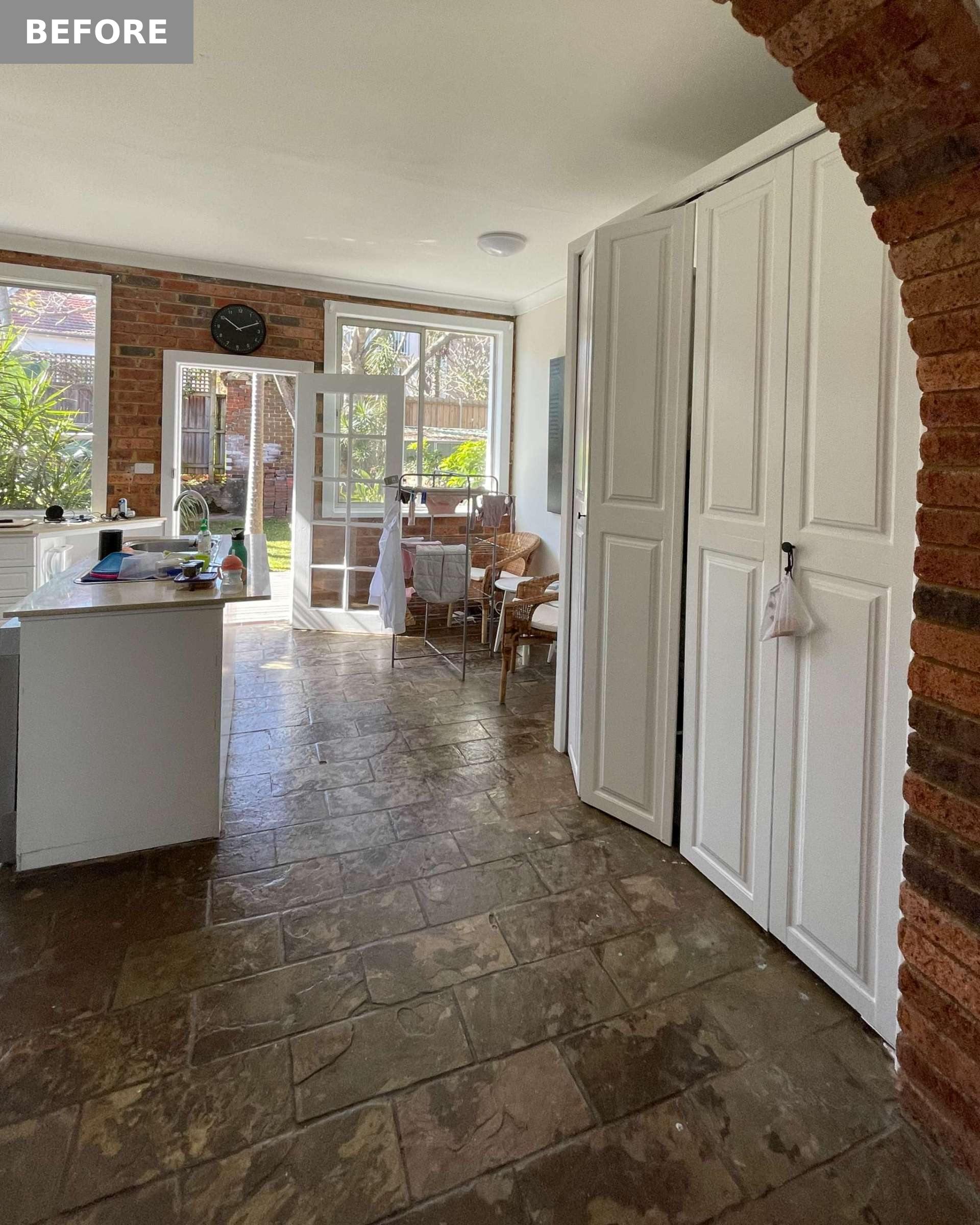 BEFORE - In the kitchen, which is at the rear of the home, clutter collected on the island, and corner shelving became a catch-all, highlighting the lack of purposeful storage.
