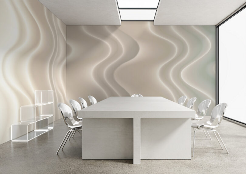 Modern conference room with a large white table, clear chairs, wavy patterned walls, and minimalist shelving in a brightly lit space