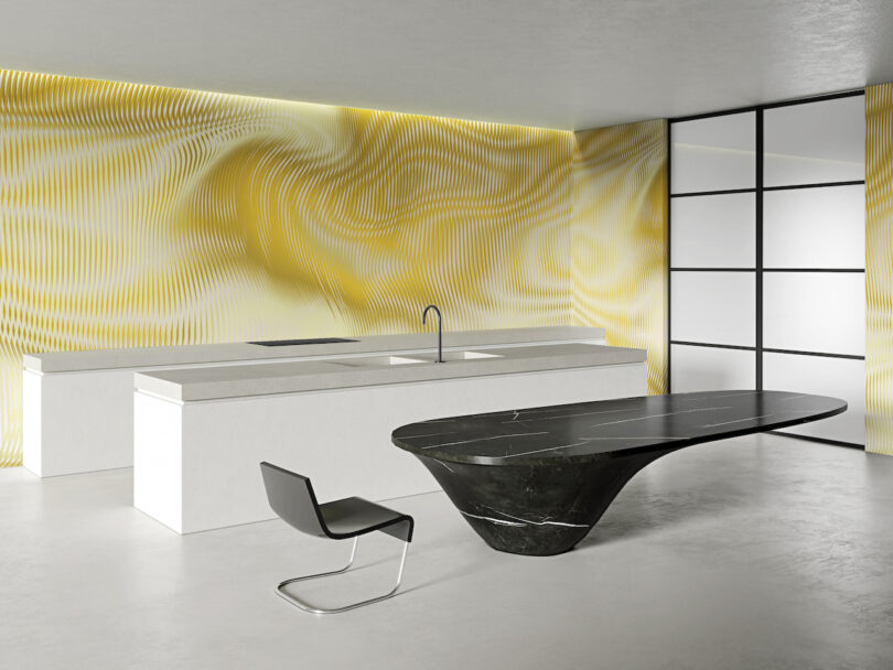 Modern kitchen with white minimalist cabinetry, a black sculptural island table, a single black chair, and a yellow and white abstract patterned wall