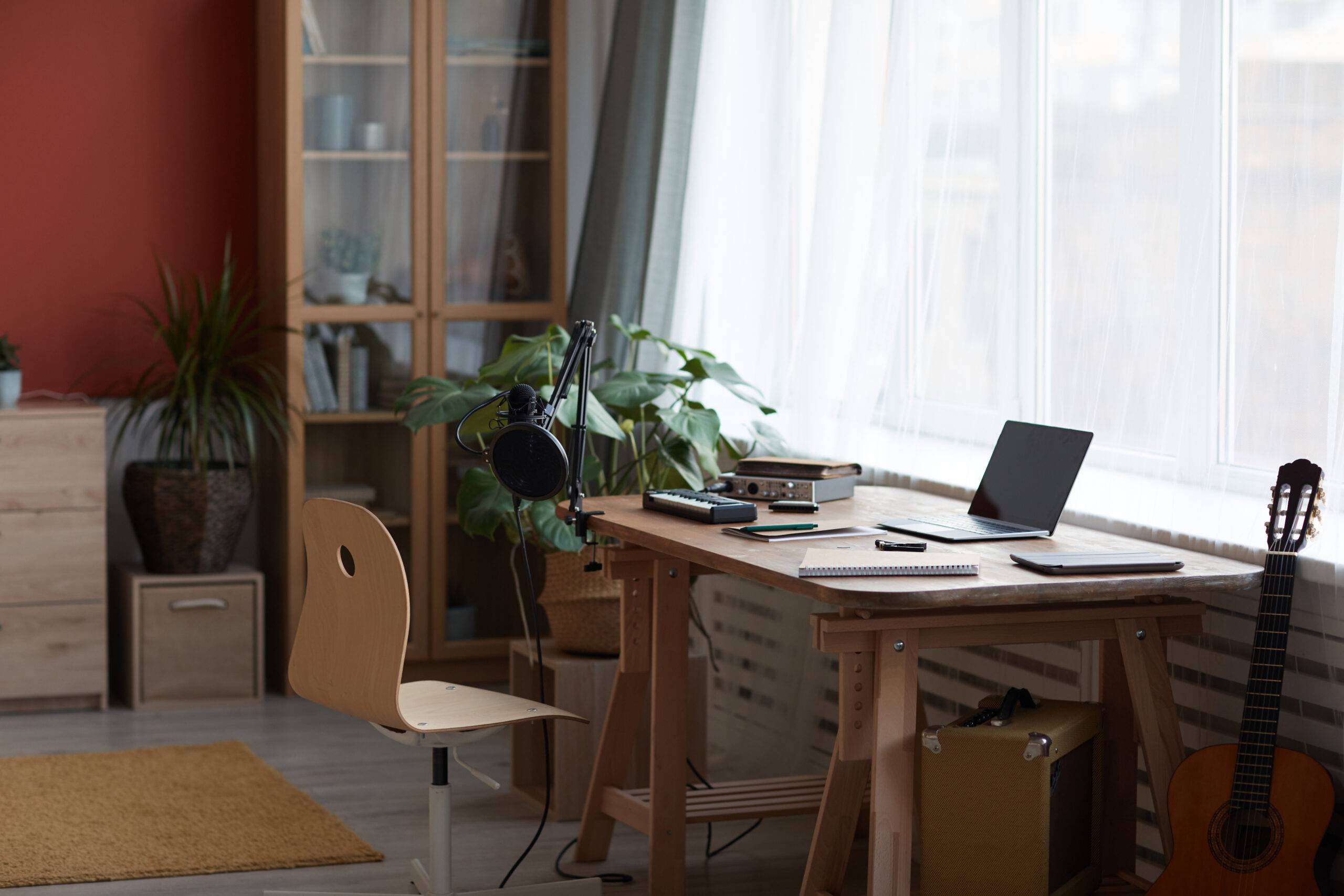 Background image of inviting home recording studio with music equipment and guitar, copy space
