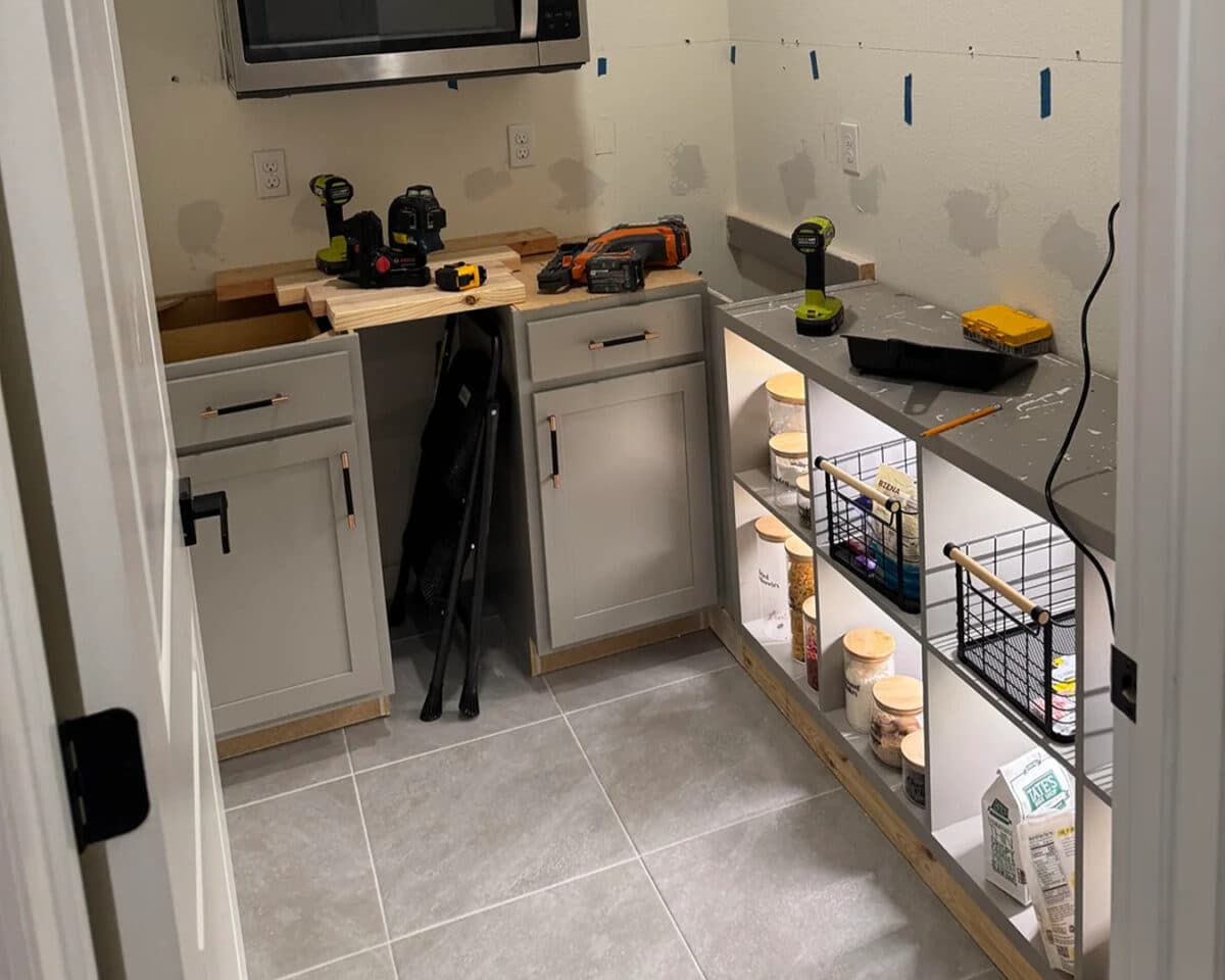 a kitchen pantry with cabinets and tools under renovation