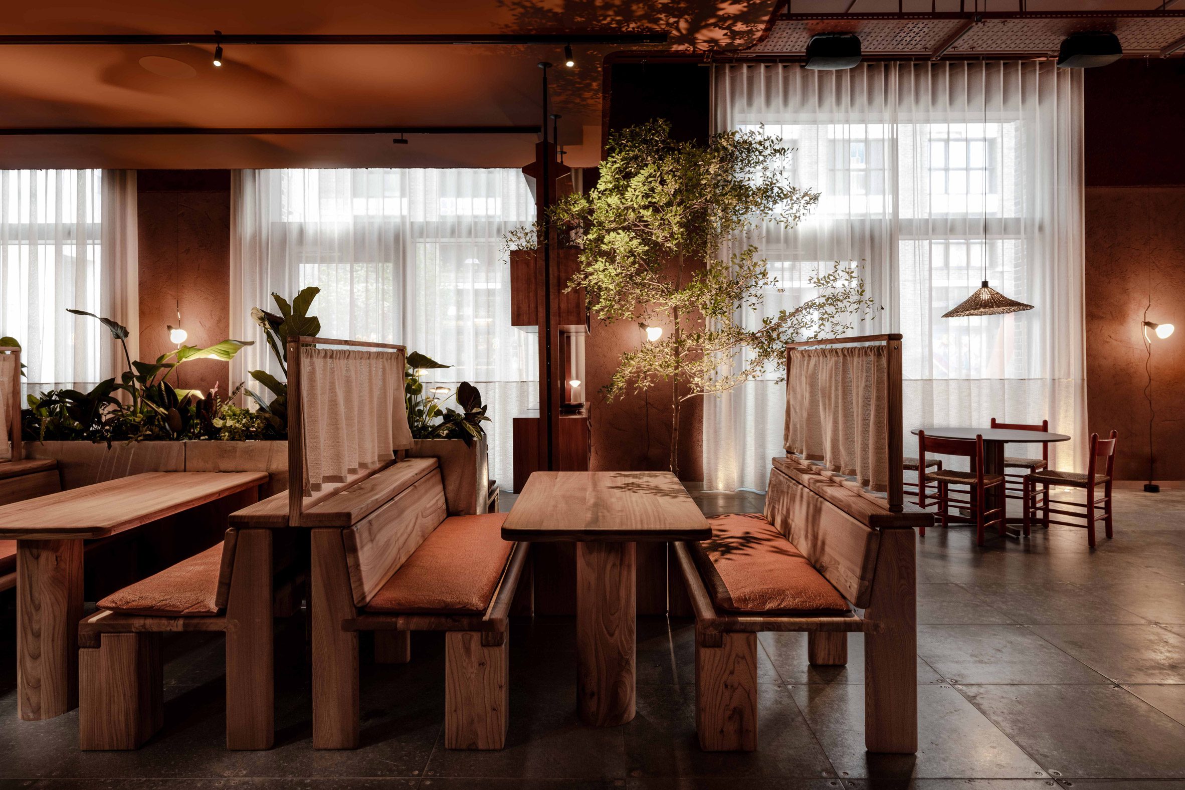 Seating booths in London restaurant by Nina + Co