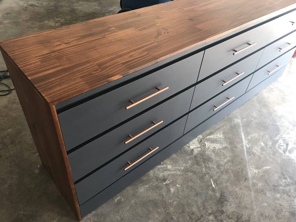 IKEA long chest of drawers in black with copper pulls