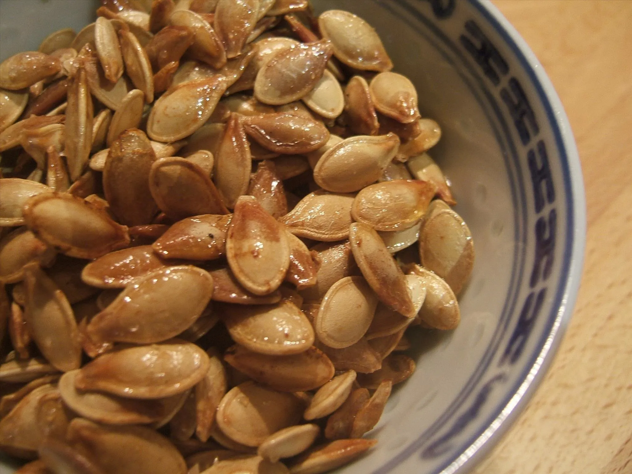 Toasted pumpkin seeds in a decorative bowl.