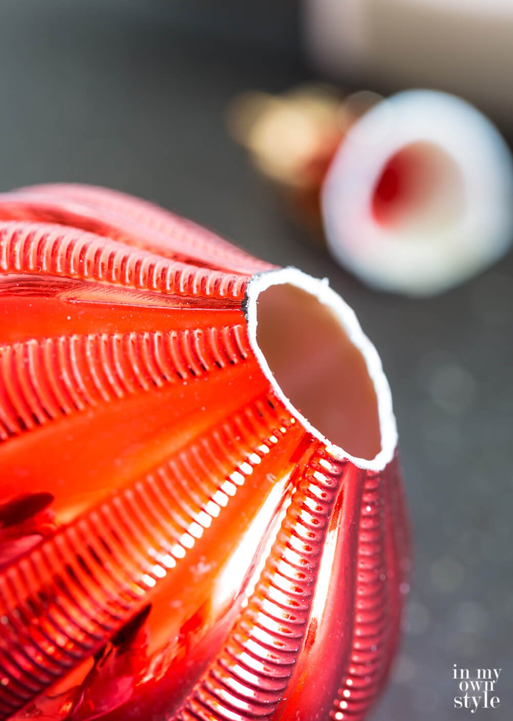 One way to cut a shatterproof Christmas ornament to make it into a lamp finial.