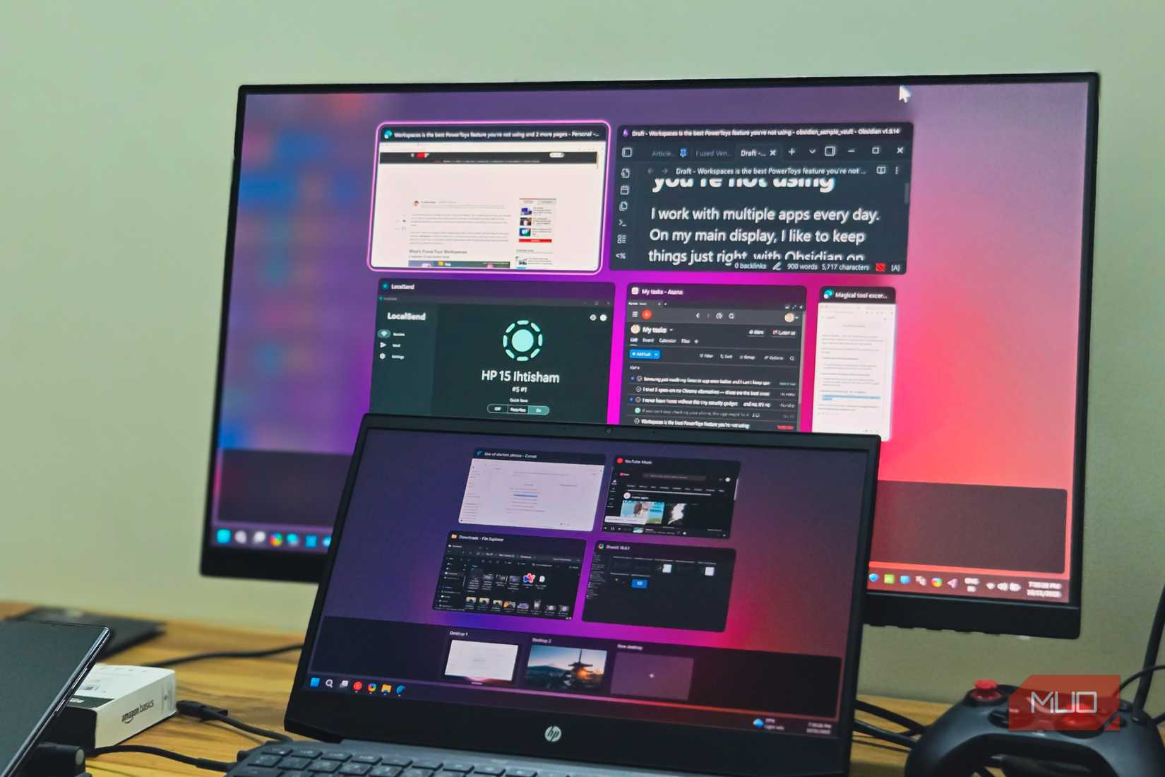 An HP Laptop and a BENQ monitor dual display setup kept on a wooden table