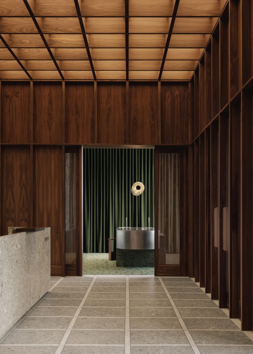A grid created by walnut panelling continues on a coffered ceiling and across terrazzo flooring